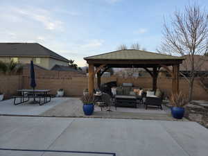 Fenced backyard with a patio area, a gazebo, grilling area, and an outdoor living / dining area