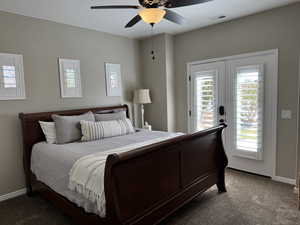 Carpeted bedroom with access to outside, a ceiling fan, and french doors