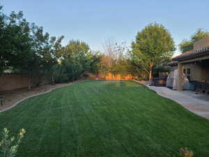 Fenced backyard with a patio area
