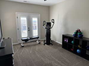 Exercise room with french doors and dark carpet