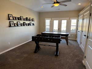 Playroom with french doors, a ceiling fan, dark carpet, and recessed lighting
