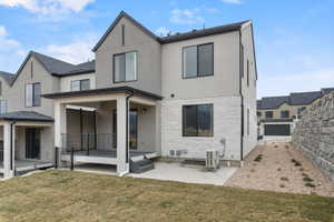Back of property with a patio area and stucco siding
