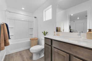 Full bath featuring vanity, shower / bath combination with curtain, light wood-type flooring, and recessed lighting