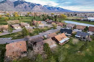 Aerial perspective of suburban area with a water and mountain view and a golf club