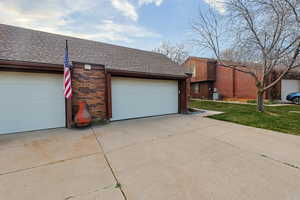 Garage featuring concrete driveway
