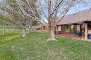 View of green lawn with a deck
