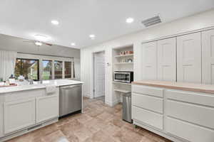 Kitchen with stainless steel appliances, white cabinetry, open shelves, ceiling fan, and recessed lighting