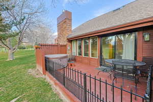 Deck featuring a patio, outdoor dining area, and a hot tub