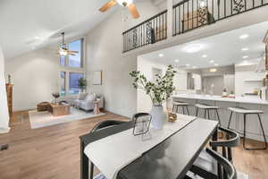 Dining space featuring recessed lighting, a ceiling fan, light wood finished floors, and vaulted ceiling