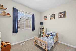 Bedroom with baseboards and carpet