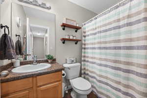 Bathroom with vanity, a shower with curtain, and dark tile patterned floors