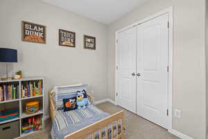 Bedroom featuring a closet and light colored carpet