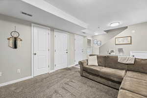 Carpeted living room with baseboards