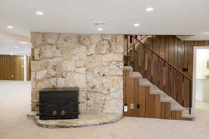 Stairs featuring carpet, wooden walls, and recessed lighting