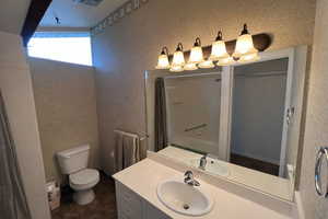 Full bathroom featuring wallpapered walls, vanity, and a shower with curtain