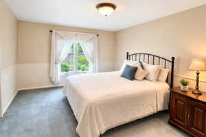 Bedroom featuring carpet flooring and baseboards