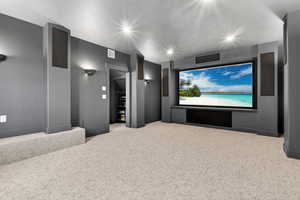 Cinema room featuring light carpet and recessed lighting