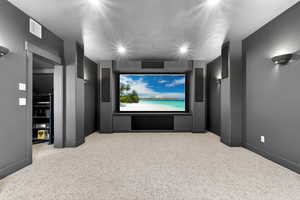 Cinema room featuring light colored carpet and recessed lighting