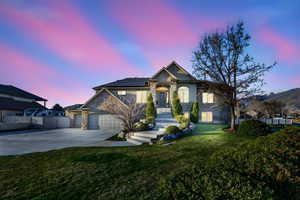 Craftsman-style home featuring stone siding, solar panels, a garage, driveway, and a standing seam roof