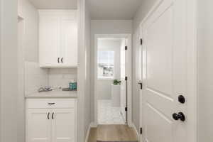 Hallway with baseboards and light wood finished floors