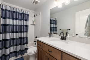 Full bath with vanity and shower / bath combination with curtain