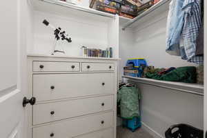 Walk in closet featuring light colored carpet