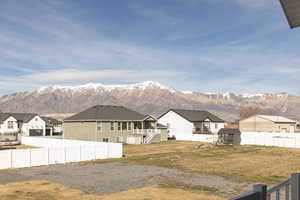 View of yard with a residential view, a mountain view, and a balcony