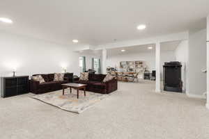 Living area featuring light carpet and recessed lighting