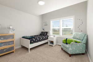 Bedroom with baseboards and light colored carpet