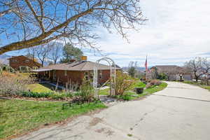 View of property exterior with a yard and brick siding