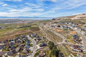View of rural area with nearby suburban area, mountains, and farmland