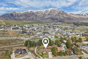 Aerial perspective of suburban area featuring a mountainous background
