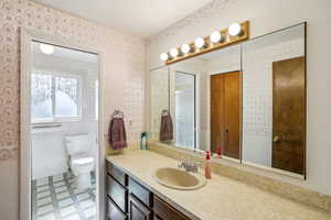 Bathroom featuring light flooring and vanity
