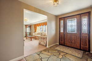 Foyer with light colored rock and a textured ceiling