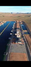 Aerial view of sparsely populated area featuring a water and mountain view