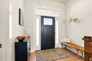 Foyer entrance featuring light wood finished floors