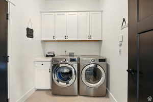 Washroom with cabinet space, washer and dryer
