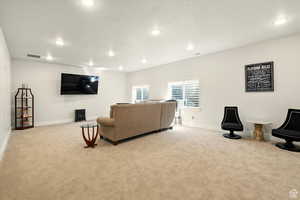 Large living area with tall ceilings and recessed lighting