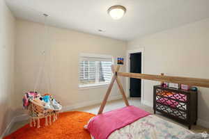 Large carpeted basement bedroom #2 and faux stone window well.