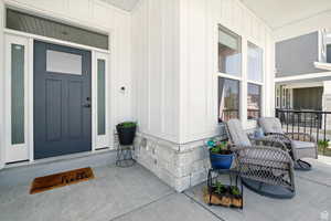 Entrance to property featuring a porch and board and batten siding