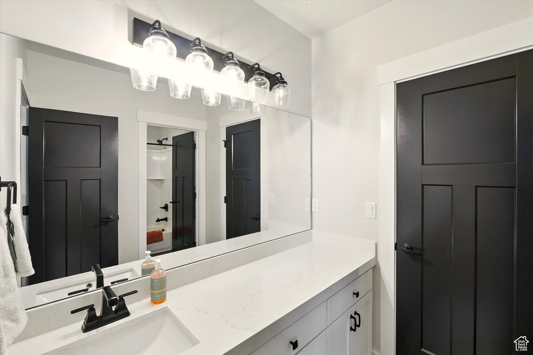 Full bath with vanity and a shower