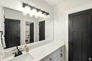 Full bath with vanity and a shower