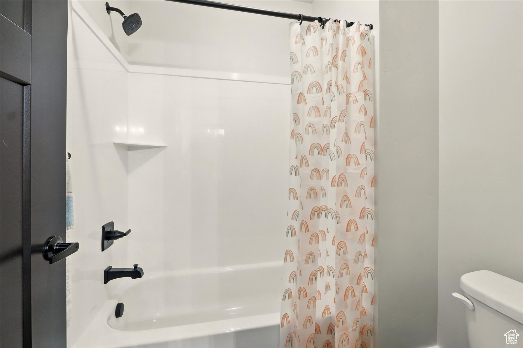 Full Jack & Jill basement bathroom featuring shower / bathtub combination and toilet