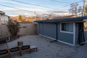 Fenced backyard with a mountain view and an outdoor structure