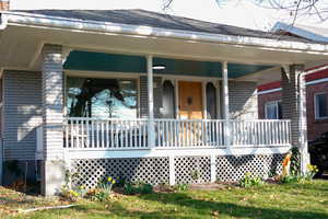 View of front of property with brick siding and covered porch