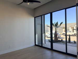 Empty room with dark wood-type flooring, ceiling fan, and recessed lighting