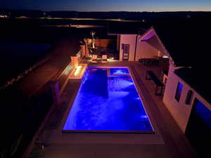 Swimming pool featuring a patio, an in-ground hot tub, and outdoor dining area