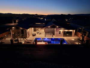 Rear view of house with a patio, a fenced backyard, and an outdoor hangout area