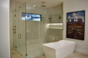 Full bathroom with a soaking tub and a stall shower