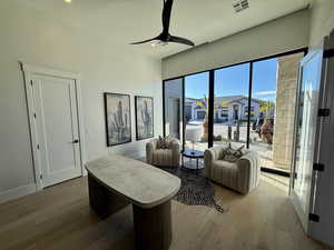 Living area featuring a ceiling fan, light wood finished floors, and recessed lighting